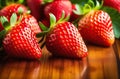 Fresh strawberries in a bowl on wooden table with low key scene. Royalty Free Stock Photo