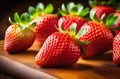 Fresh strawberries in a bowl on wooden table with low key scene. Royalty Free Stock Photo