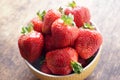 Fresh strawberries in a bowl on a wooden table. Fresh strawberries in a bowl on a wooden table. Vegetarianism, vegan