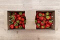 Fresh strawberries in a cardboard basket lying on a wooden table. Royalty Free Stock Photo