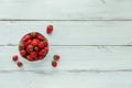 Fresh strawberries on ceramic bowl top view. Healthy food on white wooden table mock up. Delicious, sweet, juicy and Royalty Free Stock Photo