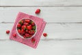 Fresh strawberries on ceramic bowl top view. Healthy food on white wooden table mock up. Delicious, sweet, juicy and ripe berry Royalty Free Stock Photo