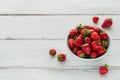 Fresh strawberries on ceramic bowl top view. Healthy food on white wooden table mockup. Delicious, sweet, juicy and ripe berry Royalty Free Stock Photo