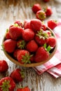 Fresh strawberries in a ceramic bowl on a wooden table Royalty Free Stock Photo