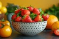 Fresh strawberries in a colander closeup