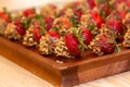 Fresh strawberries covered with dark chocolate and nuts Royalty Free Stock Photo