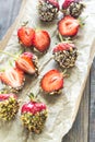 Fresh strawberries covered with dark chocolate and nuts Royalty Free Stock Photo