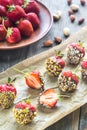 Fresh strawberries covered with dark chocolate and nuts Royalty Free Stock Photo