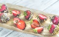 Fresh strawberries covered with dark chocolate and nuts Royalty Free Stock Photo