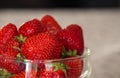 Fresh strawberries in glass bowl. Ripe strawberry closeup. Sweet summer harvest. Juicy dessert. Healthy food. Red berries in vase. Royalty Free Stock Photo
