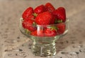 Fresh strawberries in glass bowl on table. Ripe strawberry closeup. Sweet summer harvest. Juicy dessert. Healthy food. Royalty Free Stock Photo