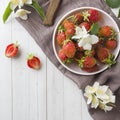 Fresh strawberries and Jasmine flowers on a light background. Summer concept. Copy space Royalty Free Stock Photo
