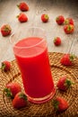 Strawberries juice on wooden background Royalty Free Stock Photo