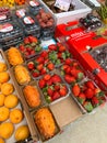 Budva, Montenegro - 25 december 2022: Fresh strawberries, kiwanos, peaches lie in boxes on the counter of the store