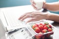 Fresh strawberries on office desk with woman drinking milk, Heal Royalty Free Stock Photo