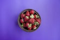 Fresh strawberries in a plate on a dark purple background Royalty Free Stock Photo