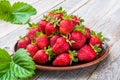 Fresh strawberries on a plate on a wooden table Royalty Free Stock Photo