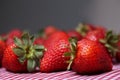 Fresh Strawberries Sitting on Red Gingham Tablecloth Royalty Free Stock Photo