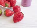 Fresh strawberries, smoothies organic dieting on a wooden background