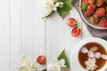 Fresh strawberries and tea with Jasmine flowers on a light background. Summer concept. Copy space Royalty Free Stock Photo