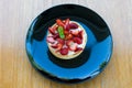 Fresh strawberries on top Cheesecake in black plate on wooden bo Royalty Free Stock Photo