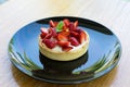 Fresh strawberries on top Cheesecake in black plate on wooden bo Royalty Free Stock Photo