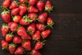 Fresh strawberries on a vintage black wooden background, tempting display