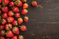 Fresh strawberries on a vintage black wooden background, tempting display