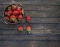 Fresh strawberries in vintage copper colander on wooden background. Royalty Free Stock Photo