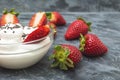 Fresh strawberries with whipped cream on dark background Royalty Free Stock Photo