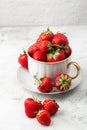 Fresh strawberries in a white cup on marble white table. Fresh nice strawberries. Strawberry field on fruit farm. Heap of Red Royalty Free Stock Photo