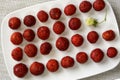 Fresh strawberries on a white plate. Singling out one from the crowd. Red and white strawberries. Collecting berries. Background Royalty Free Stock Photo