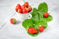 Fresh strawberries in a white porcelain bowl on wooden table in Royalty Free Stock Photo