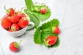 Fresh strawberries in a white porcelain bowl on wooden table in Royalty Free Stock Photo