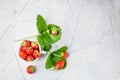 Fresh strawberries in a white porcelain bowl on wooden table in Royalty Free Stock Photo