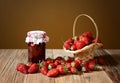 Fresh strawberries in a wicker basket and jam in a jar Royalty Free Stock Photo