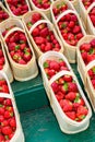 Fresh strawberries in wooden baskets at farmer`s market Royalty Free Stock Photo