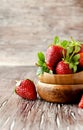 Fresh strawberries in a wooden bowl, selective focus Royalty Free Stock Photo