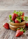 Fresh strawberries in a wooden bowl, selective focus Royalty Free Stock Photo