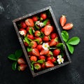 Fresh strawberries in a wooden box. Berries Top view. Royalty Free Stock Photo