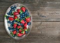 Fresh strawberry and blueberry mix on a metal dish (tray) over a Royalty Free Stock Photo