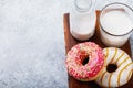 Fresh strawberry and caramel donuts with cedar milk on a wooden stand