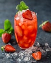 Fresh strawberry cocktail. Fresh summer cocktail with strawberry and ice cubes. Glass of strawberry soda drink on dark background. Royalty Free Stock Photo