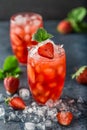 Fresh strawberry cocktail. Fresh summer cocktail with strawberry and ice cubes. Glass of strawberry soda drink on dark background. Royalty Free Stock Photo