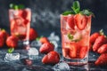 Fresh strawberry cocktail. Fresh summer cocktail with strawberry and ice cubes. Glass of strawberry soda drink on dark background Royalty Free Stock Photo