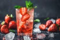Fresh strawberry cocktail. Fresh summer cocktail with strawberry and ice cubes. Glass of strawberry soda drink on dark background Royalty Free Stock Photo
