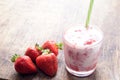 Fresh strawberry cocktail milkshake on a wooden background. Healthy food for breakfast and snacks.