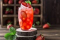 Fresh strawberry cocktail. Fresh summer cocktail with strawberry and ice cubes. Glass of strawberry soda drink on dark background. Royalty Free Stock Photo