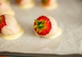 A fresh strawberry covered in white chocolate