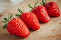 Fresh strawberry on a dark wood background, close up of big strawberry on wood